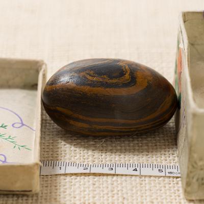Seer stone associated with Joseph Smith, long side view, and storage box, with metric tape measure